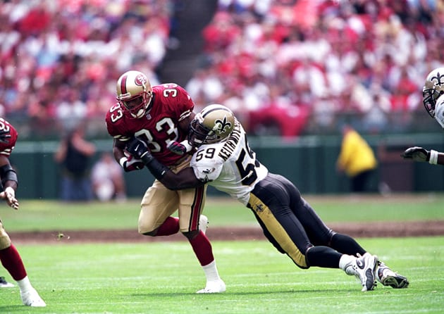 Lawrence Phillips (33) of the San Francisco 49ers moves with the ball as Keith Mitchell (59) of the New Orleans Saints tries to tackle him.